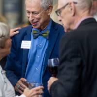 Group of three event attendees talking together